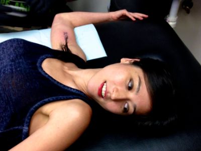 Mina Kimes is lying down after just getting her tattoo.